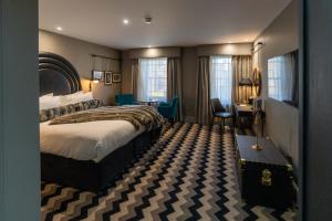 a hotel room with a large bed and a desk at Hotel Gotham Newcastle in Newcastle upon Tyne +91 photos