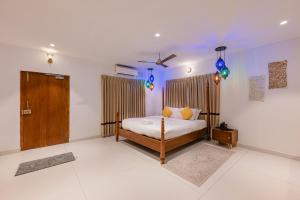 a bedroom with a bed and a wooden door at Bangalore Bubble Stay 1BHK Villa - Bella in Denkanikota