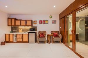 a kitchen with two chairs and a table in a room at Bangalore Bubble Stay 1BHK Villa - Bella in Denkanikota