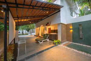 a patio of a house with a couch and a table at Bangalore Bubble Stay 1BHK Villa - Bella in Denkanikota