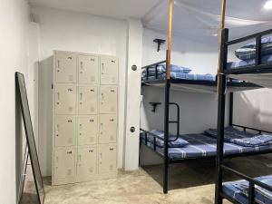 a room with three bunk beds and some cabinets at Paradise Sunset Beach in Koh Rong Sanloem
