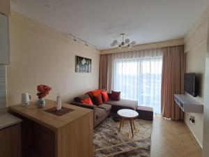 a living room with a couch and a table at Comfy Bnb in Syokimau
