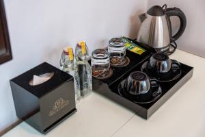 a table with a tea set and a tea kettle at Thai Ha Hotel in Ha Long