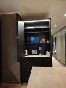 a room with a door with a microwave and a counter at ArticLoft Kemi in Kemi