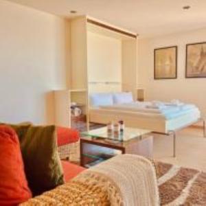 a living room with a couch and a bed at Penthaus Horizont mit Meerblick in Lübeck