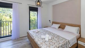 a bedroom with a bed with two candles on it at Villa Tea - Kremena by Villas Guide in Blace +24 photos