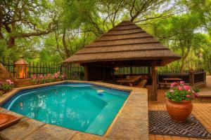 a gazebo and a swimming pool with a pavilion at Tree Lodge by My Adventure House in Marloth Park