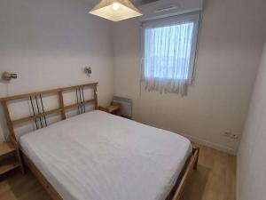 a small bedroom with a bed and a window at Confortable appartement 4 personnes avec balcon, parking à Stella Plage - FR-1-236-173 in Stella-Plage