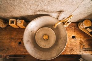 a dirty toilet with a metal seat in a room at Lo Chalet Du Village in Chambave