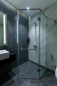 a bathroom with a glass shower and a sink at Quy Nhon Alt cosy apartment in Quy Nhon +96 photos