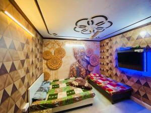 a bedroom with a bed and a painting on the wall at RS Hotel in Amritsar
