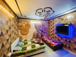 a bedroom with a bed and a painting on the wall at RS Hotel in Amritsar