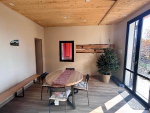 a dining room with a table and chairs and a window at Case Monte Arso -Etna sud est- in Ragalna
