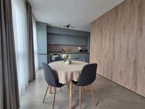 a dining room with a table and chairs at XTN house AIRPORT in Cluj-Napoca