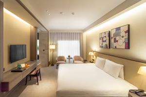 a hotel room with a bed and a desk at HUAN Serviced Residence in Taichung