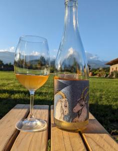 a bottle of wine next to a wine glass at Chubini Winery & Cabins in Kvareli