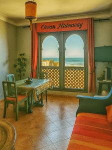 a dining room with a table and a view of the ocean at Ocean Hideaway - Sea View in Essaouira