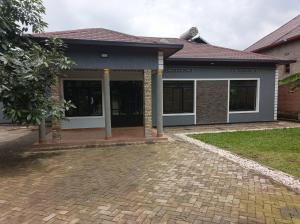 a house with a brick driveway in front of it at Happy Home House in Ruhengeri