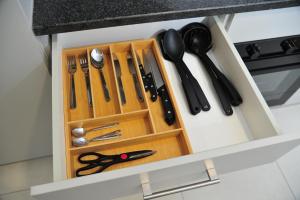 a drawer filled with utensils in a kitchen at Sentlhaga 1 Bed Self Catering Apartment, Sarona City,Habitat Kappa, Gaborone in Gaborone