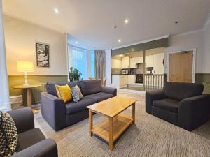 a living room with a couch and a table at Derwent Manor Apartments & Rooms in Keswick
