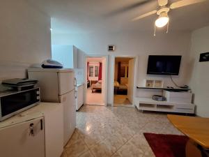 a kitchen with white appliances and a living room at Apartement Irena Vir in Vir +15 photos