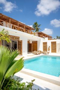 an exterior view of a villa with a swimming pool at Coconut Villas Zanzibar in Matemwe