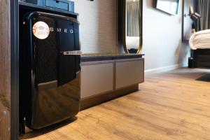 a refrigerator in a room with a wooden floor at Original Sokos Hotel Vaakuna Hämeenlinna in Hämeenlinna