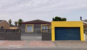 Unit 1, TraversHub Sleeps 6 Self-Catering Group Belhar, CT في Belhar: منزل فيه باب جراج وسياج +18 صورة