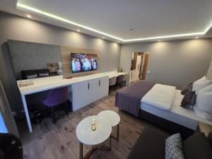 a hotel room with a bed and a desk at TeMax Lux Hahnenklee in Goslar