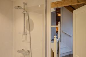 a shower with a glass door in a bathroom at Appartement B Rosita in Twisk