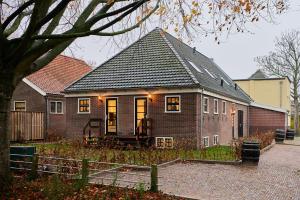 a brick house with a black roof at Appartement B Rosita in Twisk
