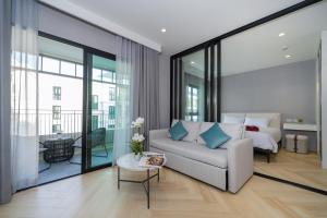 a living room with a couch and a bed at The Title Legendary D-605 1 BR Bangtao Beach in Bang Tao Beach +26 photos