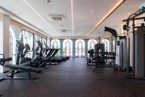 a gym with a row of treadmills and ellipticals at The Title Legendary D-605 1 BR Bangtao Beach in Bang Tao Beach