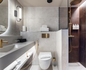 a bathroom with a toilet and a sink at Original Sokos Hotel Vaakuna Hämeenlinna in Hämeenlinna