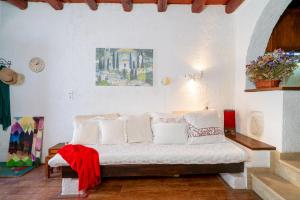 a bedroom with a bed with white pillows at Spitaki traditional house in Vóroi