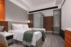Ένα ή περισσότερα κρεβάτια σε δωμάτιο στο Meisu Hotel Yongzhou Lengshuitan Municipal Party Committee Branch +5 φωτογραφίες