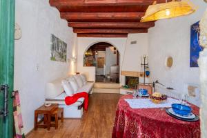 a living room with a white couch and a table at Spitaki traditional house in Vóroi