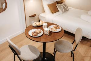 a table with plates of food on it in a living room at L'Alma- Accès Privée-Proche Aéroport-Parking-Wifi in Achenheim