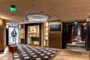 a lobby of a building with a checkered floor at Original Sokos Hotel Vaakuna Hämeenlinna in Hämeenlinna +18 photos