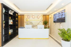 a lobby of a store with a white reception desk at The Sun Hotel Pho Co Ninh Binh in Ninh Binh