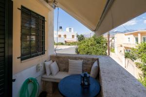 a patio with a couch and a table at Spitaki traditional house in Vóroi