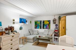 a living room with a couch and a table at Tina Risager bed & breakfast in Sindal +11 photos