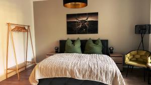 a bedroom with a bed and a picture of a deer at Ferienwohnung Seelenruh in Falkensee