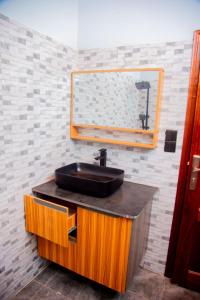 a bathroom with a sink and a mirror at Happy Home House in Ruhengeri