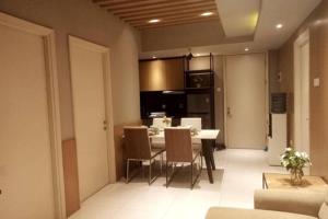 a kitchen and dining room with a table and chairs at The Asando Above Pakuwon Mall in Lontar