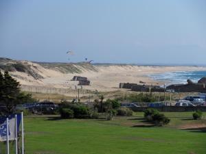 a view of a beach with a kite in the distance at Studio Residence Le Signal in Capbreton