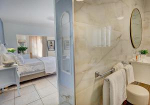 a bathroom with a shower and a bed in a room at Stay Wilderness in Wilderness +44 photos