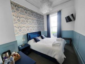 Ένα ή περισσότερα κρεβάτια σε δωμάτιο στο Kings' House