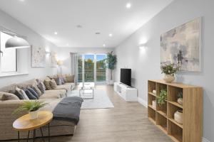 a living room with a couch and a table at The Isleworth Garden Retreat 3BR 2BA with Gated Parking in Isleworth