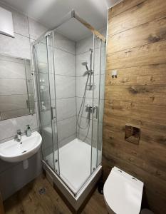 a bathroom with a shower and a toilet and a sink at FOKA Hostel in Wrocław +42 photos
